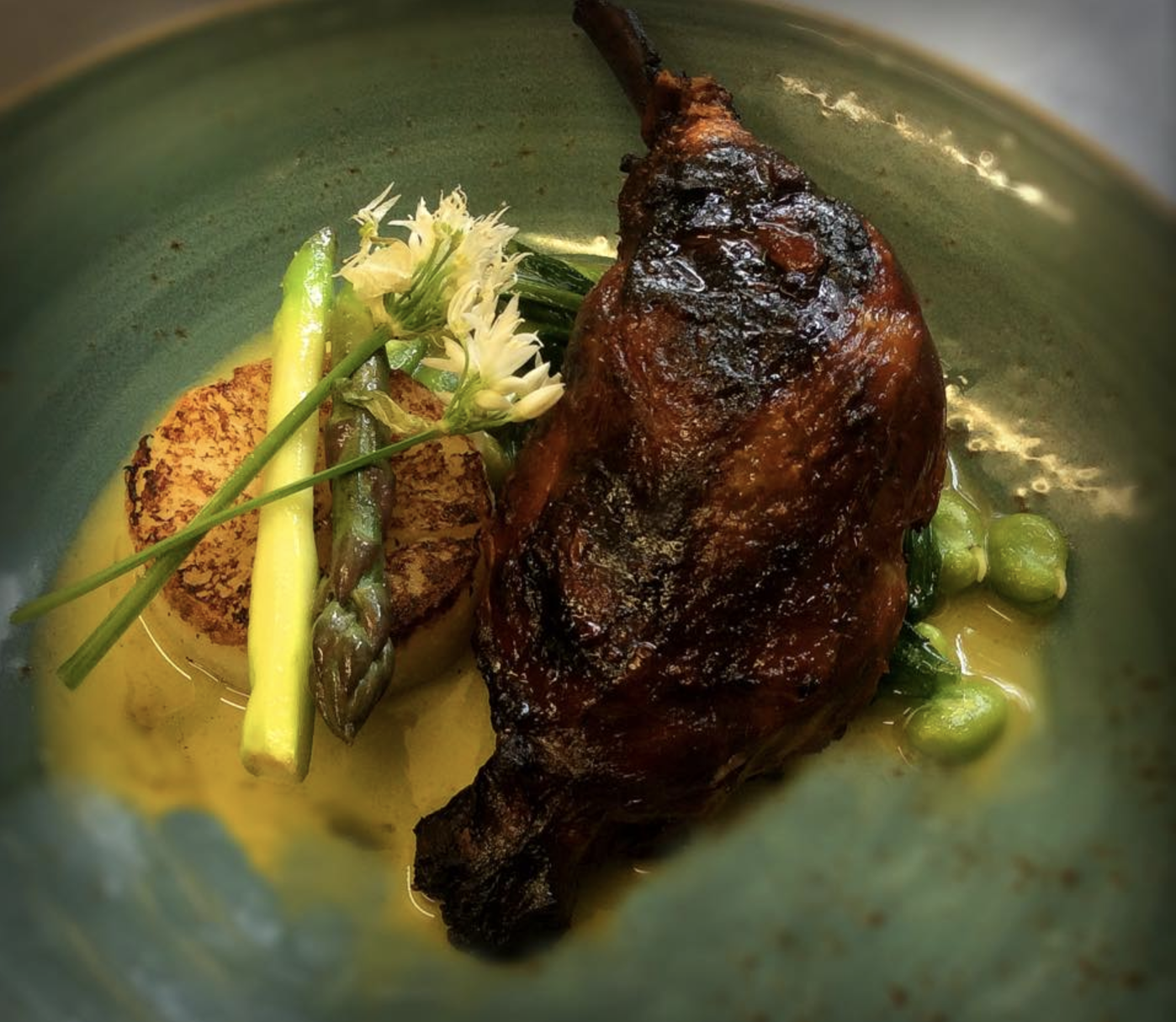 Confit duck leg, fondant potato, fricasse of broad bean, pea, wild garlic & purple asparagus